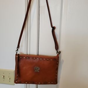 Envelope bag with zip top, wrist strap and crossover strap.